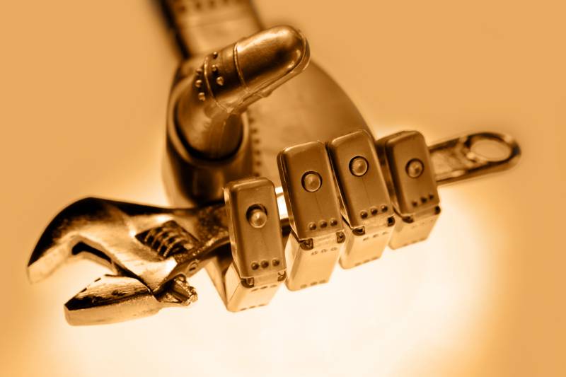 A robotic hand holding a spanner