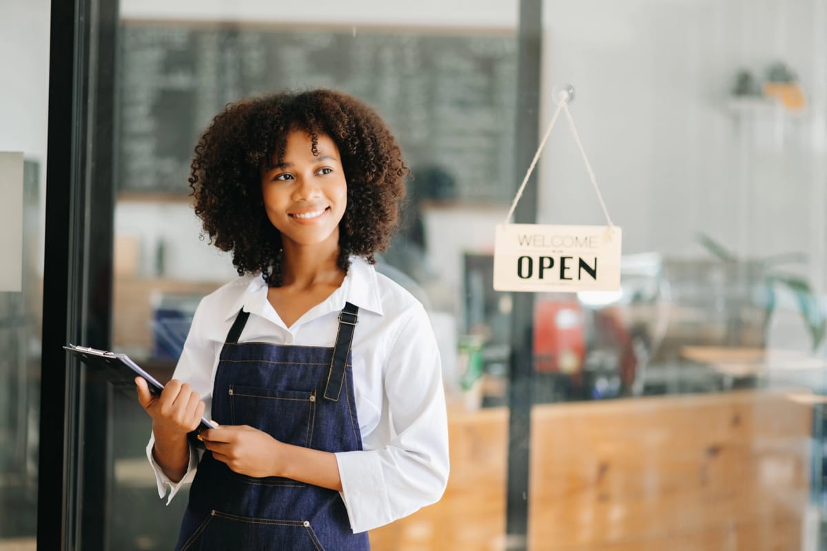 An entrepreneur standing in front of their store